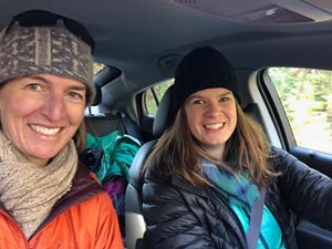 Two women smiling as they carpool.