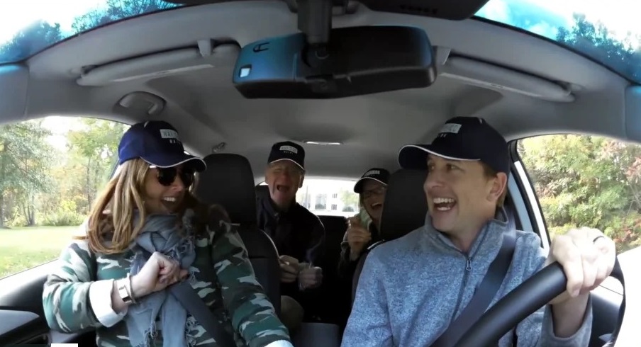 Four people smiling in a carpool all wearing Way 2 GO MAINE hats.